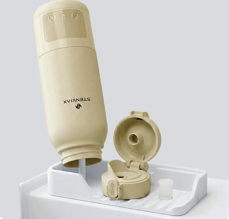 The Silk Beige warmer standing upside down on a drying tray beside its opened lid and silicone seal