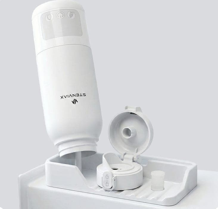 The Luxe White warmer standing upside down on a drying tray beside its opened lid and silicone seal